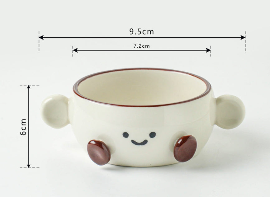 Cute ceramic bowl with smiley face design and dimensions on a white background